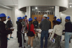 A group of people in hardhats in a construction space.